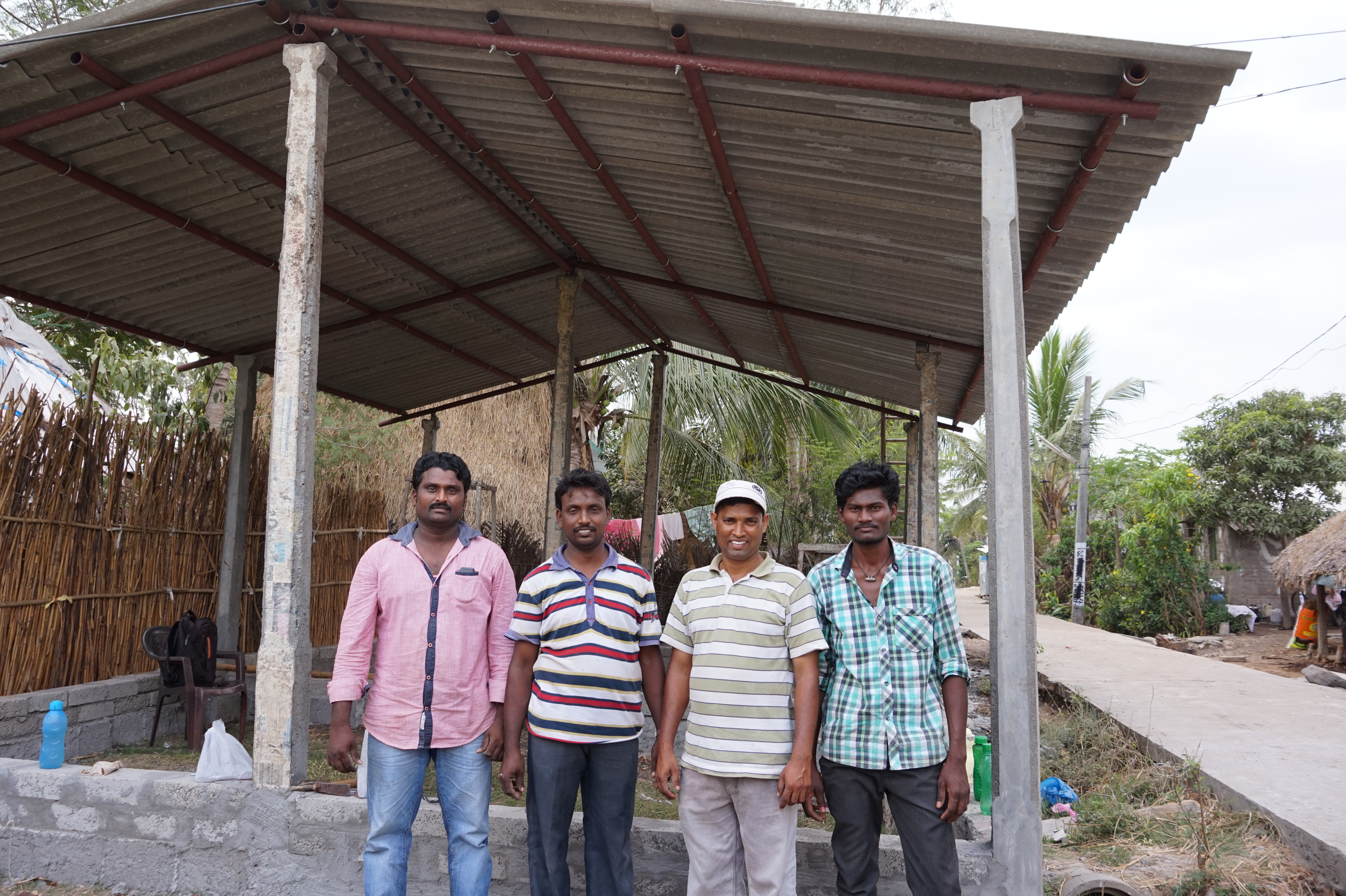 Pr Joseph (second from left) stands with Narishimama, Nayadu and Suresh in front of the prayer hall